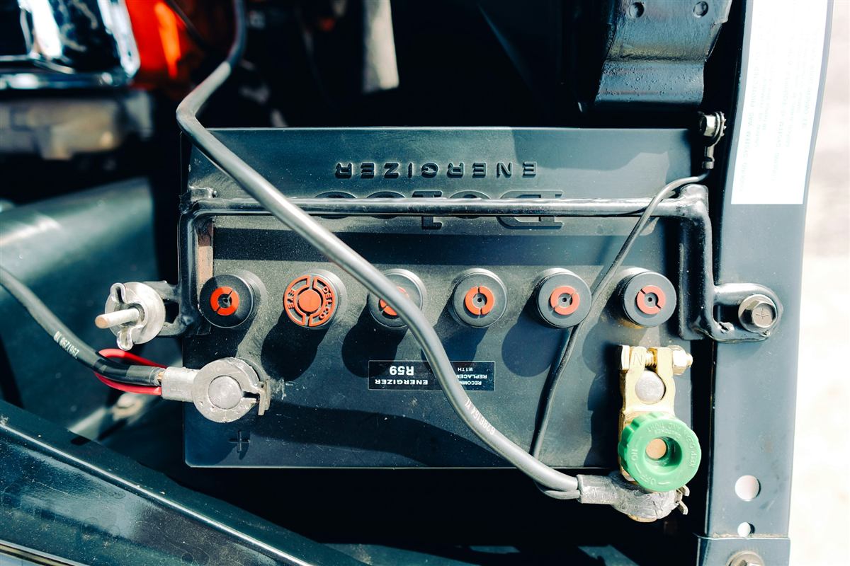 Bateria de carro com cabos conectados no compartimento do motor